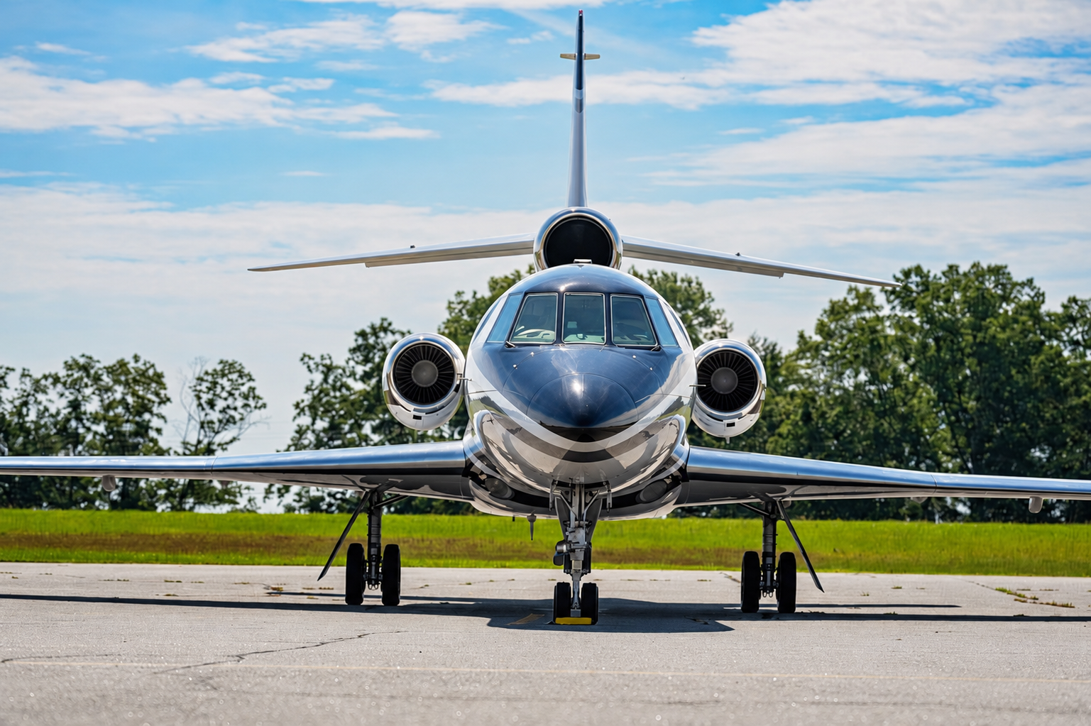 Front view of a blue and silver Falcon aircraft